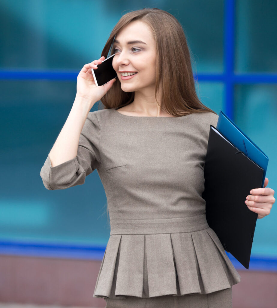 portrait of beautiful woman making business call on the street